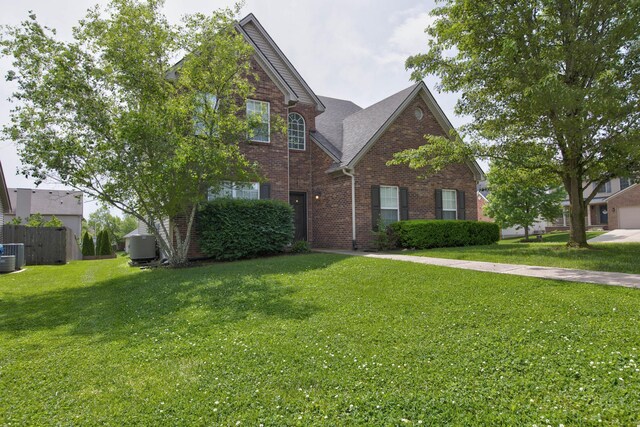 view of front of home featuring a front yard and central air condition unit