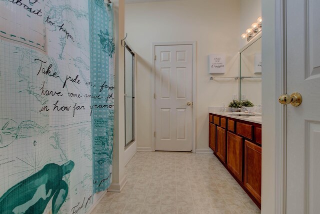 bathroom featuring vanity and a shower with door