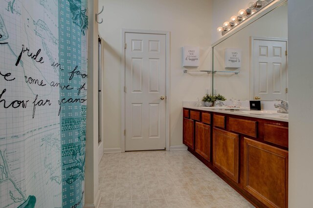 bathroom with vanity and a shower