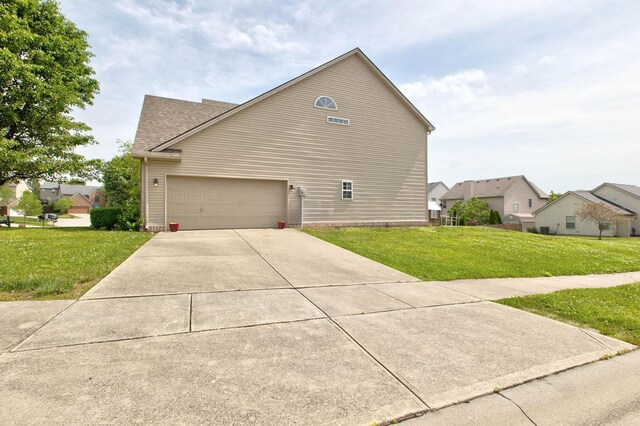 view of front of property with a front lawn and a garage