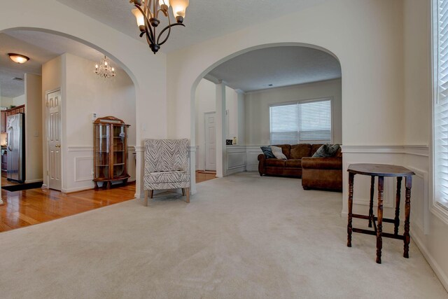 living area featuring hardwood / wood-style floors and a chandelier