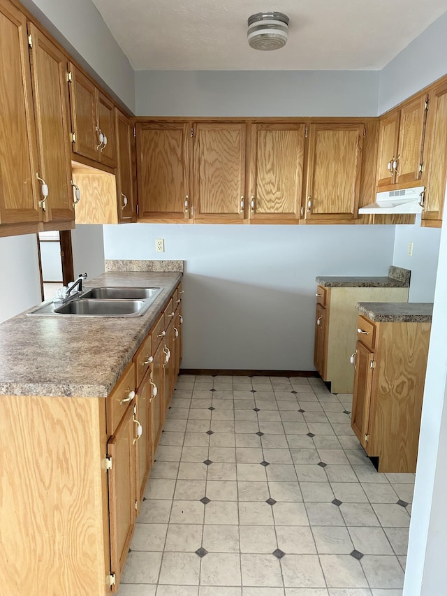 kitchen with light tile floors and sink