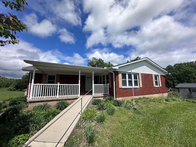 view of front facade with a front yard and covered porch