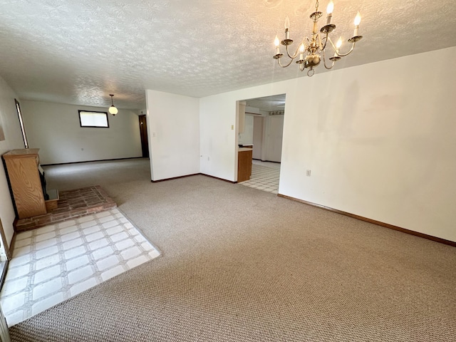 interior space with a textured ceiling, carpet floors, and a chandelier