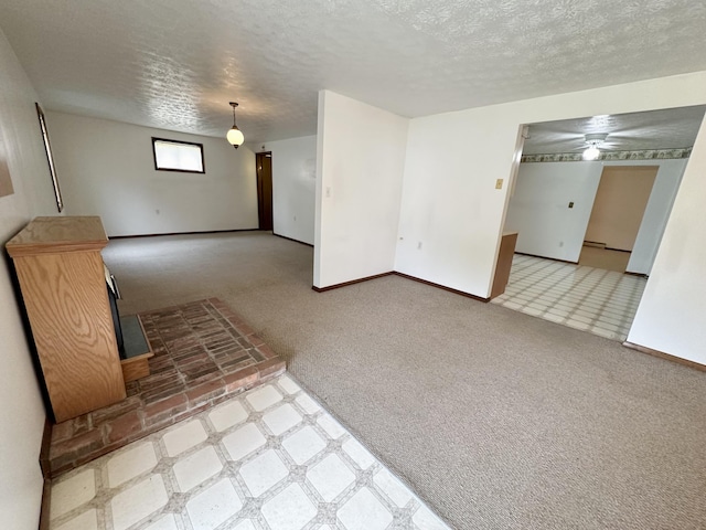 unfurnished living room featuring a textured ceiling and light carpet