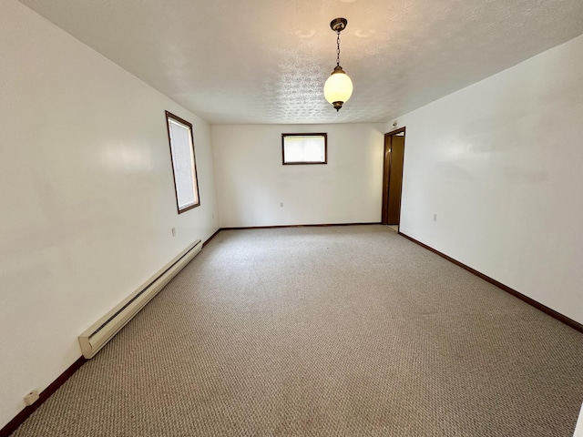 unfurnished room featuring carpet, a baseboard heating unit, and a textured ceiling