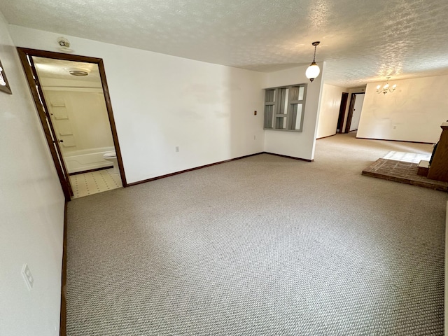 unfurnished living room with carpet flooring and a textured ceiling