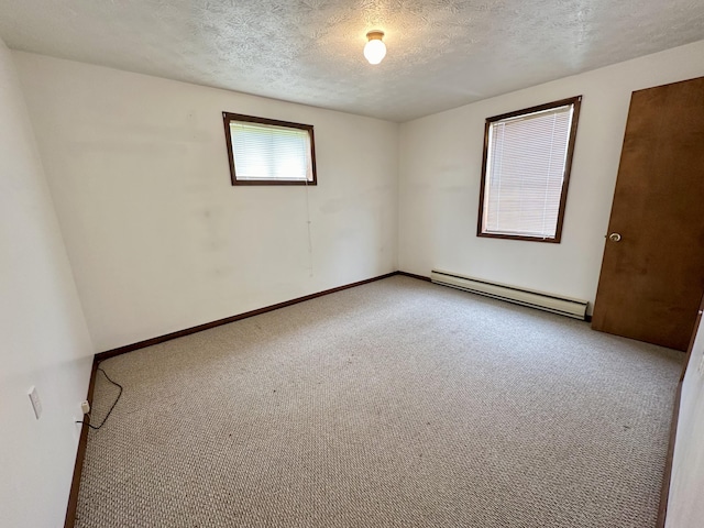 unfurnished room with a baseboard heating unit, a textured ceiling, and carpet floors