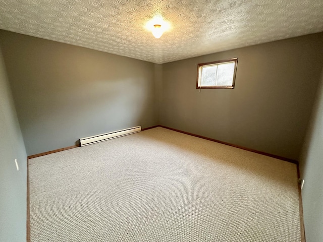 empty room with baseboard heating, carpet, and a textured ceiling