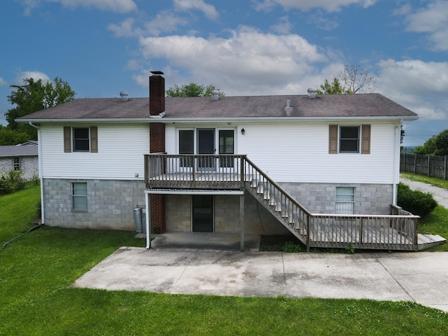 back of property with a patio area, a deck, and a lawn