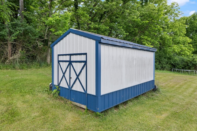 view of outbuilding featuring a lawn