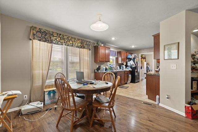 dining area featuring a wealth of natural light and light wood-type flooring