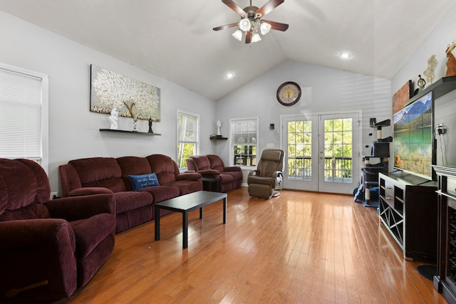 living room with high vaulted ceiling, ceiling fan, light hardwood / wood-style floors, and french doors