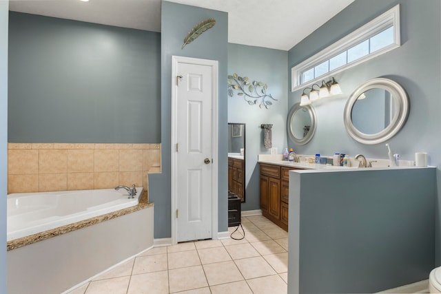 bathroom featuring a washtub, vanity, and tile floors