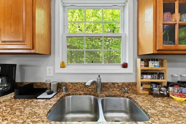 kitchen featuring sink and stone countertops