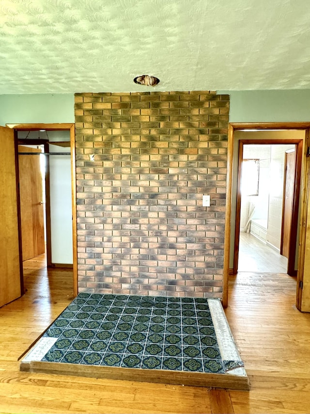 interior details featuring a textured ceiling and hardwood / wood-style flooring