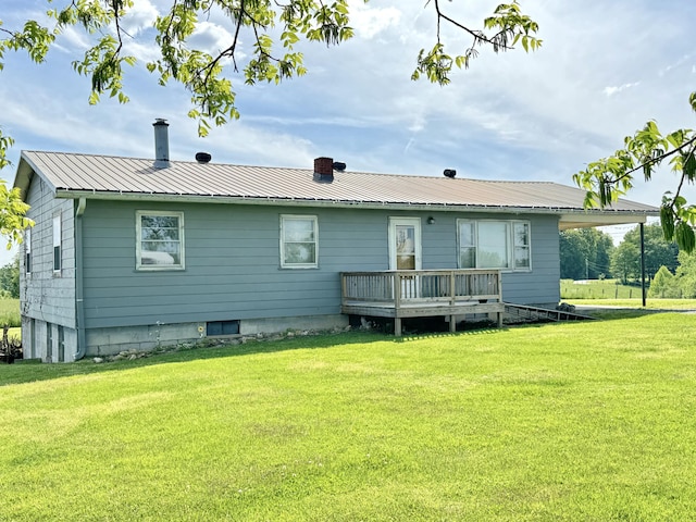 rear view of property with a deck and a yard