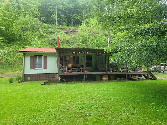 rear view of house with a yard