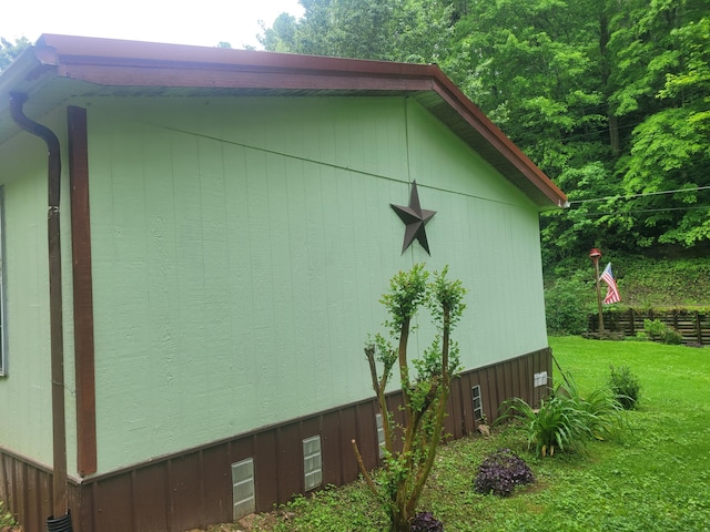 view of side of home featuring a lawn