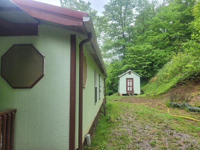 view of property exterior with a storage shed