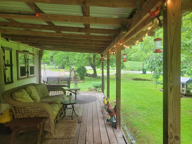 wooden terrace featuring a lawn