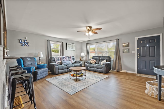 living room with a healthy amount of sunlight, ceiling fan, and light hardwood / wood-style floors