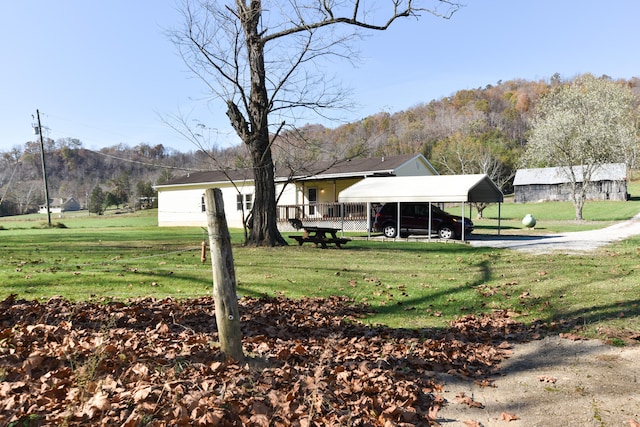 exterior space with a carport and a front lawn