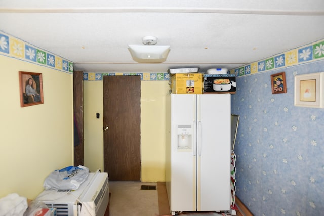 interior space featuring white refrigerator with ice dispenser