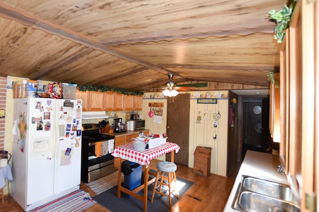 kitchen featuring lofted ceiling, appliances with stainless steel finishes, wooden ceiling, hardwood / wood-style flooring, and ceiling fan