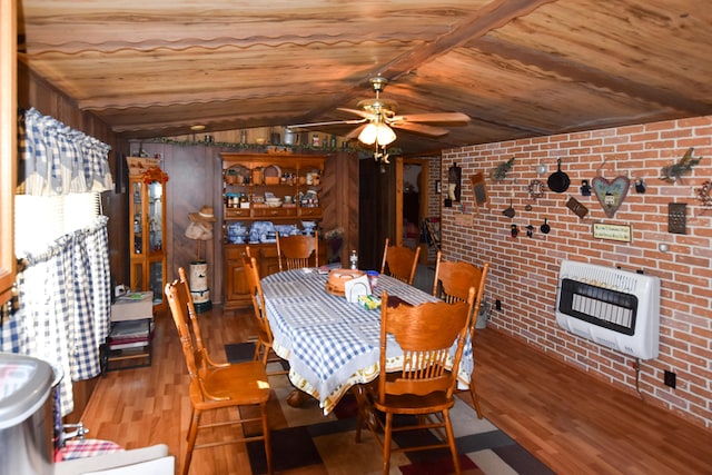 dining room featuring ceiling fan, vaulted ceiling, wood-type flooring, brick wall, and wooden ceiling