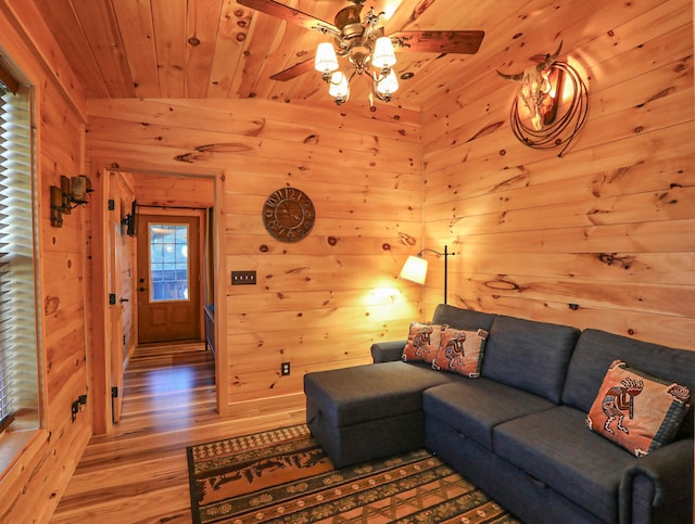 living room featuring wooden walls, wood ceiling, vaulted ceiling, and hardwood / wood-style floors