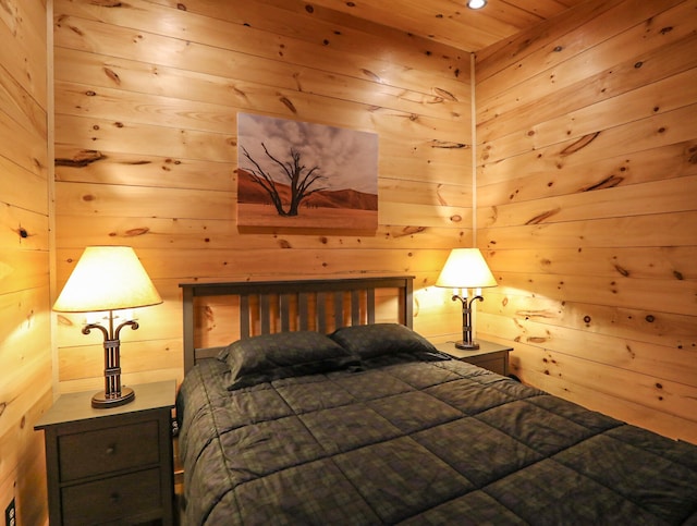 bedroom with wooden walls and wood ceiling