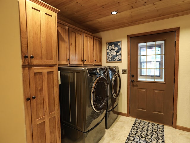 laundry area with wood ceiling, washer and dryer, and cabinets