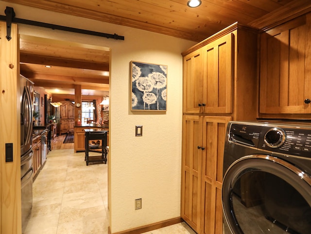 washroom featuring washer / dryer and cabinets