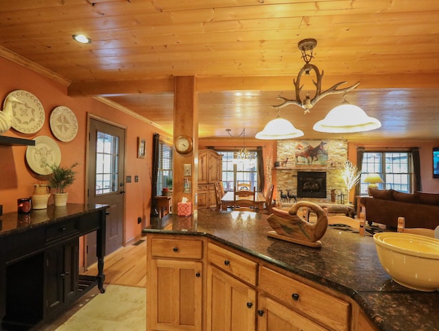 kitchen with pendant lighting, a wealth of natural light, a chandelier, and light wood-type flooring