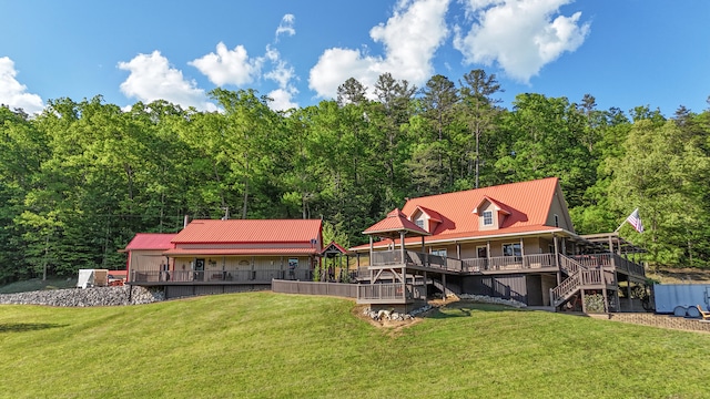 back of house featuring a wooden deck and a yard