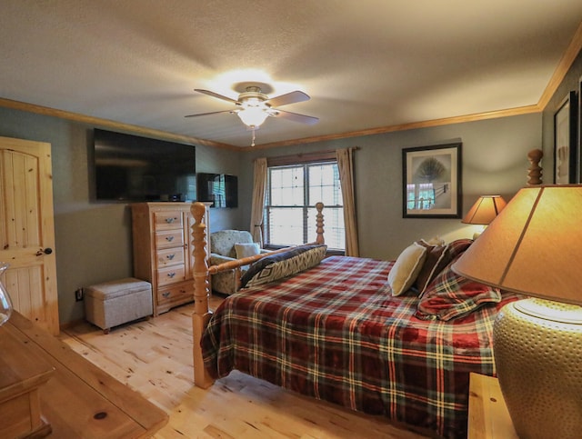 bedroom with a textured ceiling, light hardwood / wood-style floors, ceiling fan, and crown molding