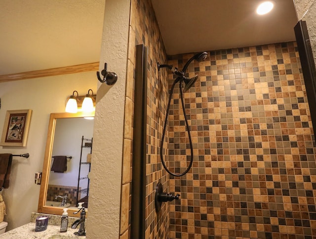 bathroom featuring sink and tiled shower