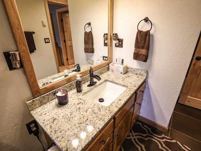 bathroom with tile patterned flooring and vanity