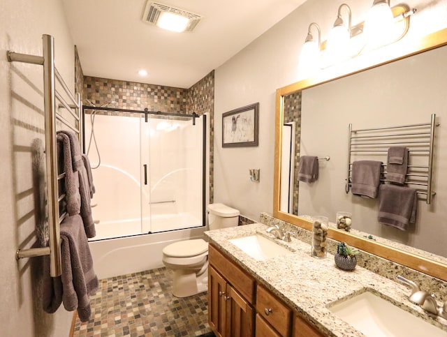 full bathroom featuring combined bath / shower with glass door, vanity, toilet, and tile patterned floors