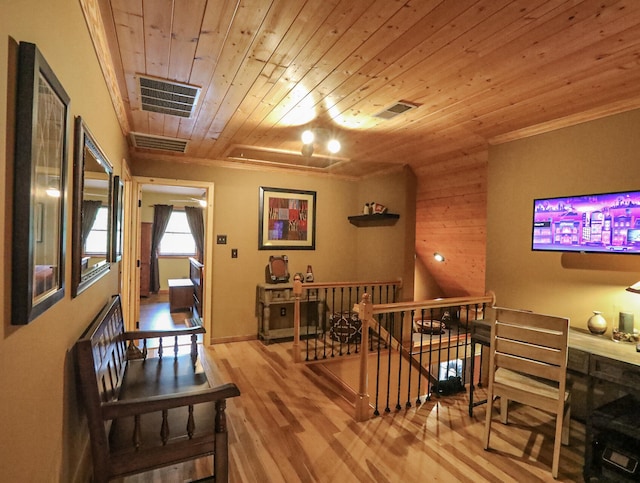 hallway with ornamental molding, wood-type flooring, and wooden ceiling