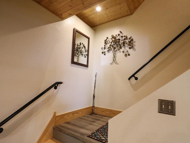 stairway with wooden ceiling and hardwood / wood-style floors