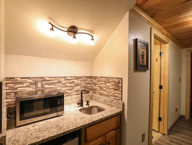 bathroom with wood-type flooring, wood ceiling, vaulted ceiling, and decorative backsplash