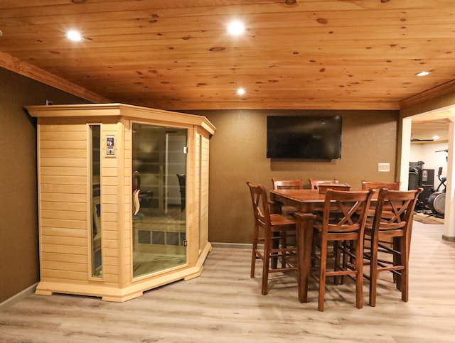 dining area featuring crown molding, wood ceiling, and light hardwood / wood-style flooring