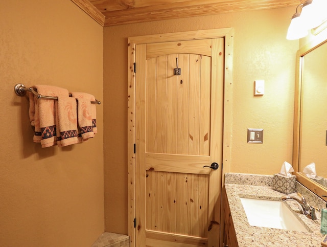 bathroom featuring vanity and crown molding