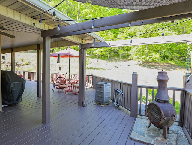 wooden deck featuring area for grilling and central AC