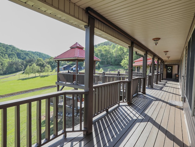 deck featuring a gazebo and a yard