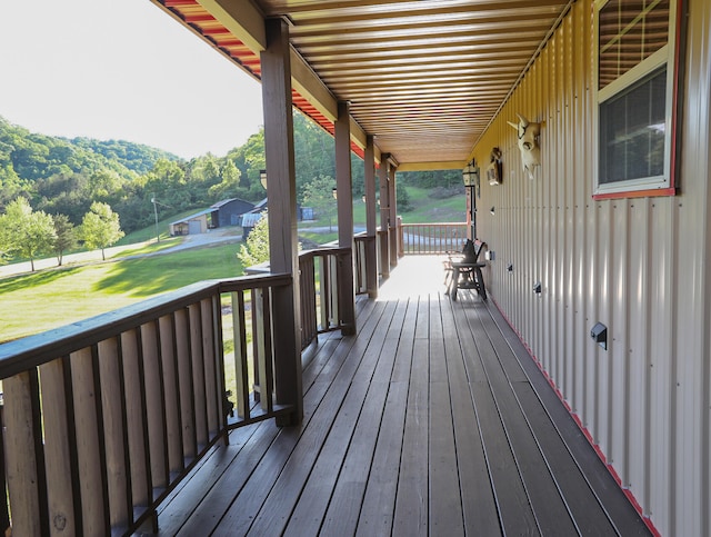 wooden terrace with a lawn