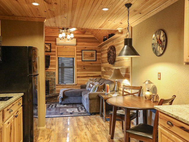 kitchen featuring vaulted ceiling, hanging light fixtures, light hardwood / wood-style floors, and wooden ceiling