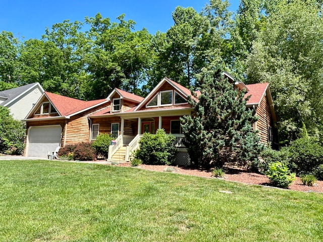 view of front of property featuring a garage, a front yard, and a porch